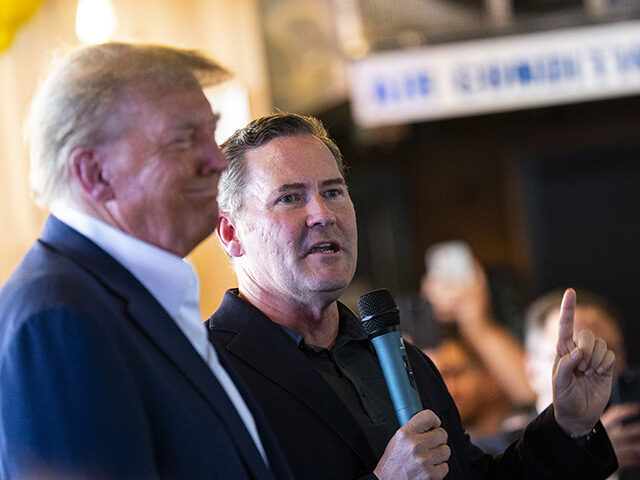 Representative Michael Waltz, a Republican from Florida, speaks with former President Dona