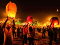 A group of young people light a Sky Lantern during the Dev Deepavali Festival at Varanasi.