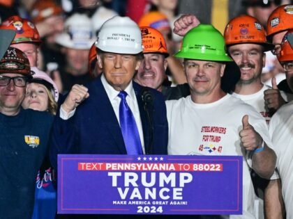 Members of "Steelworkers for Trump" pose with former US President and Republican