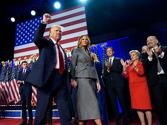 Republican presidential candidate Donald Trump raises his fist as he leaves the stage afte