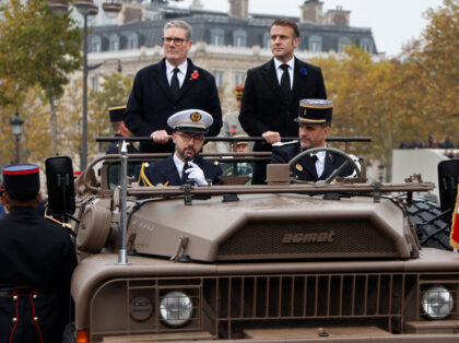 TOPSHOT - France's President Emmanuel Macron (R) and Britain's Prime Minister Ke