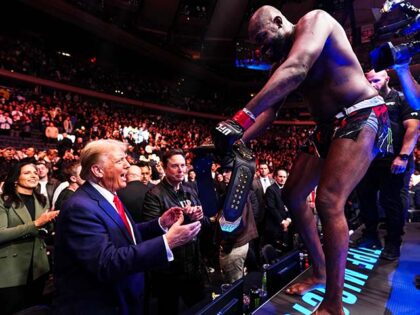 (L-R) President-elect Donald Trump holds the UFC heavyweight championship belt whilst Jon