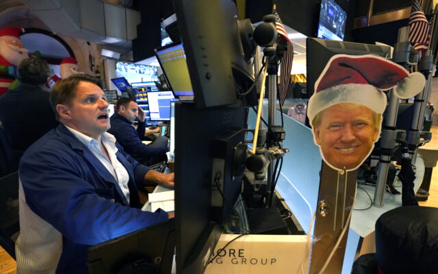 An image of US President-elect Donald Trump is displayed as traders and financial professi