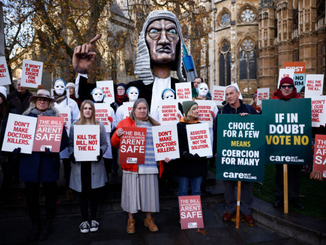 Campaigners against the assisted suicide bill hold placards at a demonstration outside The