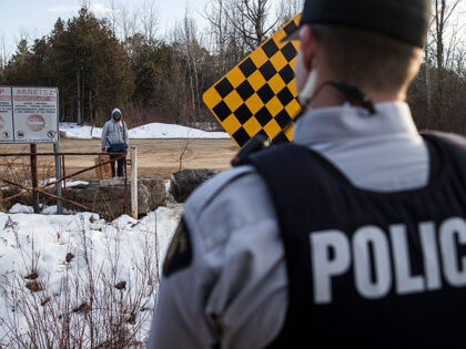 A man claiming to be from Sudan is confronted by a Royal Canadian Mounted Police officer a