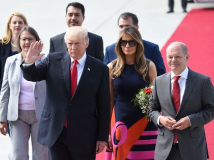 US President Donald Trump waves after he and US First Lady Melania Trump were greeted by H