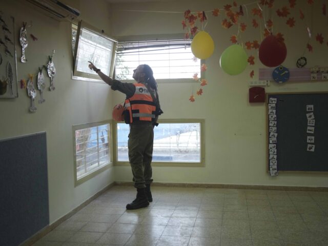 An Israeli soldier from the Homefront Command unit inspects the site where a drone launche