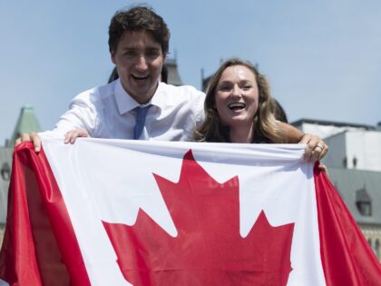 Canadian athlete Rosie MacLennan and Prime Minister Justin Trudeau hold up a Canadian flag