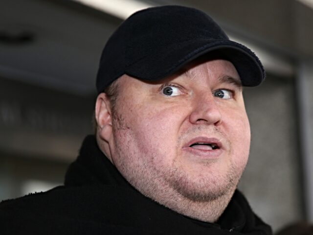 Internet mogul Kim Dotcom leaves court after a judge ruled that he and three other defenda