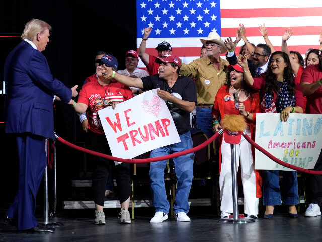 Republican presidential nominee former President Donald Trump, left, greets supporters as