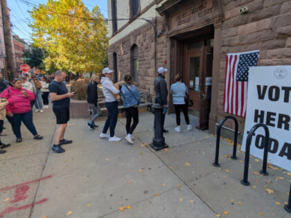 HOBOKEN, NJ - OCTOBER 26: People stand in line as they wait to vote on the first day of ea