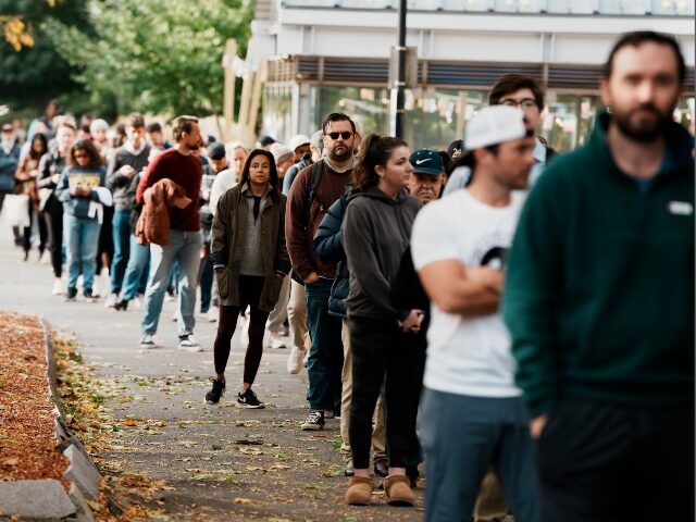 People wait in line to vote on Election Day, Tuesday, Nov. 5, 2024, in the East Boston nei