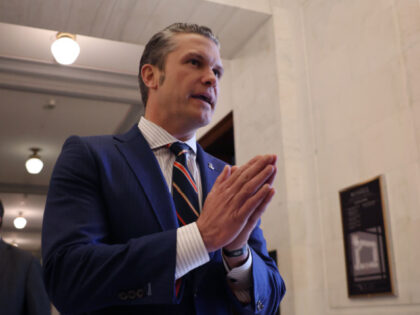 WASHINGTON, DC - NOVEMBER 21: Pete Hegseth pauses to talk to reporters after a series of m