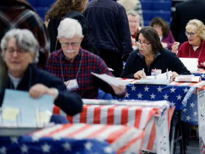 Poll workers check in voters for the presidential primary election at Windham High School,