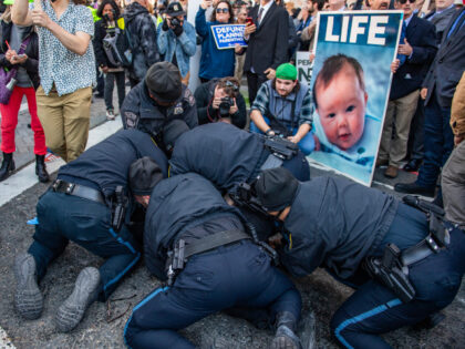 Counter-protesters are detained as they clash with police clash during an attempt to block