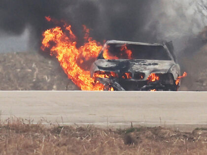 This photo provided by the North Korean government shows a burning vehicle during tests of