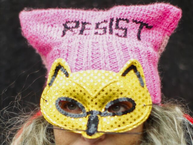 A woman takes part in a rally before the Women's March, on Saturday, Jan. 18, 2020 in