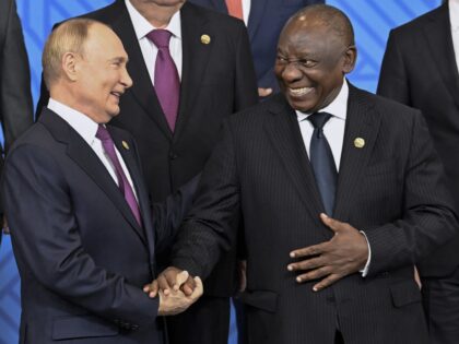 Russian President Vladimir Putin, left, and South African President Cyril Ramaphosa shake