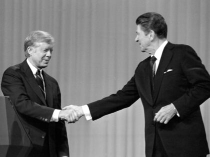 In this Oct. 28, 1980 file photo, President Jimmy Carter shakes hands with Republican Pres