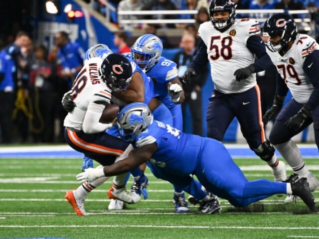 DETROIT, MI - NOVEMBER 28: Chicago Bears quarterback Caleb Williams (18) is tackled during