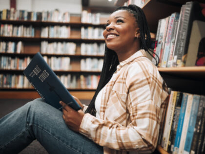 Black woman student, reading or library floor for religion, study or bible in research, fo