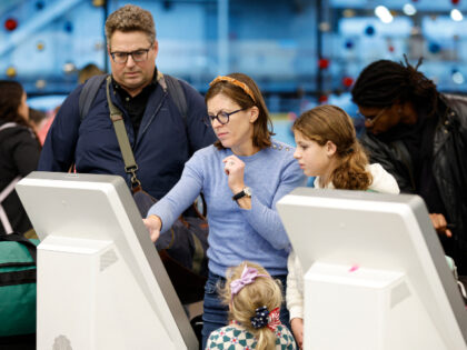 Travelers check in for their flights at O'Hare International Airport in Chicago, Illi