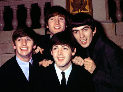 CIRCA 1964: Rock and roll band "The Beatles" pose for a portrait wearing suits i