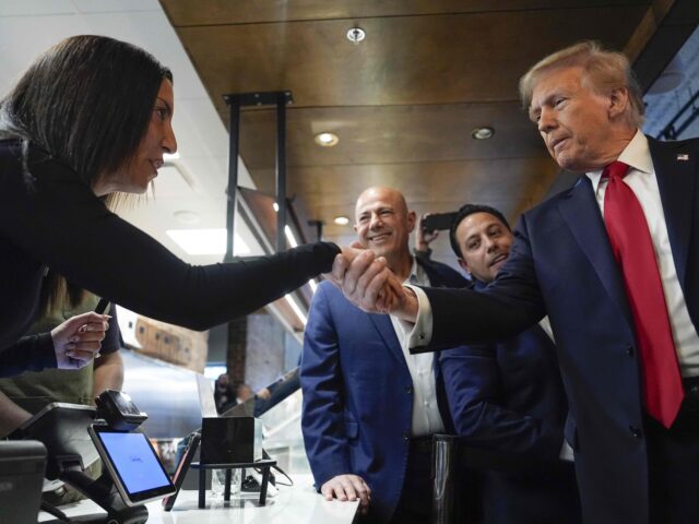 Republican presidential nominee former President Donald Trump greets people as he visits T