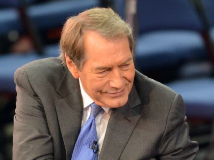 CBS MorningNews anchor Charlie Rose shakes hands with an unidentified lady August 27, 2012