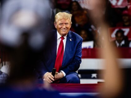 Former US President Donald Trump smiles as the crowd cheers during a town hall event at Do