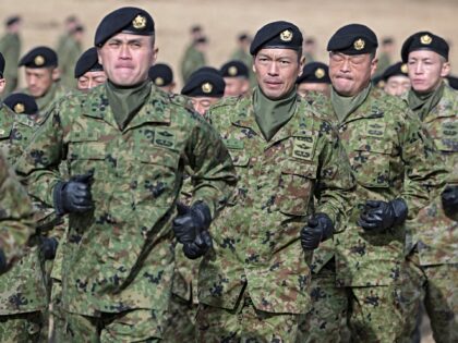 Japanese soldiers march off the field after taking part in a joint military drill and demo