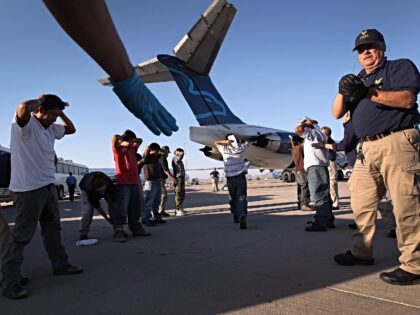 MESA, AZ - JUNE 24: Undocumented Guatemalan immigrants are body searched before boarding a