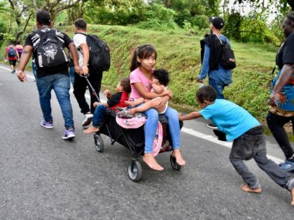 Children ride in a stroller along the Huixtla highway in the state of Chiapas, Mexico, Tue