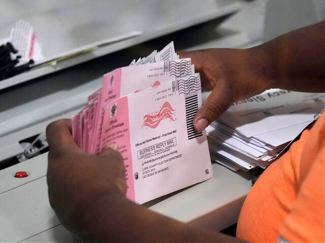 FILE - An election worker prepares mail-in ballots at the Clark County Election Department