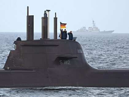 21 February 2023, Schleswig-Holstein, Eckernförde: Crew members of the submarine U32 gree