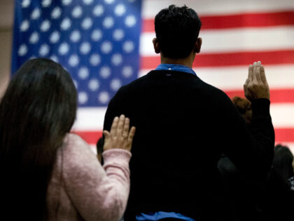 In this Feb. 15, 2017 file photo, people take the oath of citizenship during a naturalizat