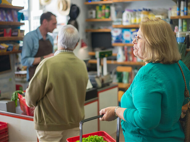 store customers carrying shopping baskets