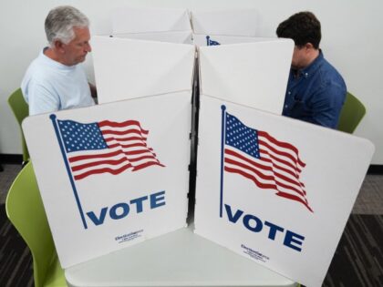 People mark their ballots at the polling place at Tysons-Pimmit Regional Library in Falls