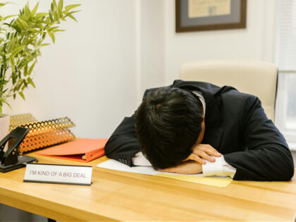 Man in a Suit Sleeping on the Desk