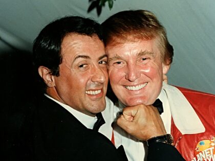 Actory Sylvester Stallone poses for a playful portrait with businessman Donald Trump at a