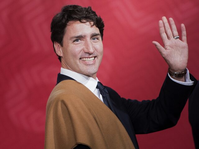 Canada's Prime Minister Justin Trudeau waves during the traditional "family photo" on the