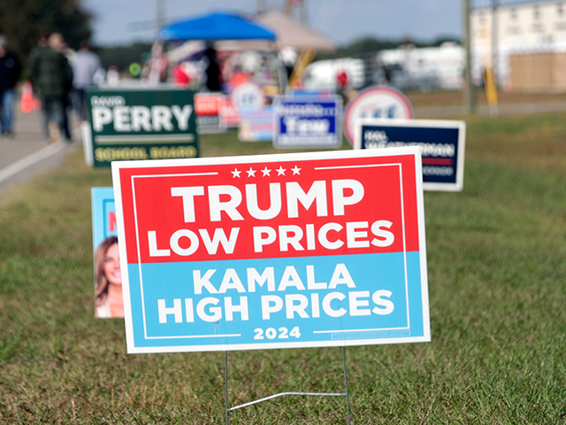 Signs for Donald Trump and state candidates are displayed outside at a campaign rally in W