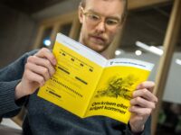 A man reads the new version of the preparedness booklet "If the crisis or war comes", that