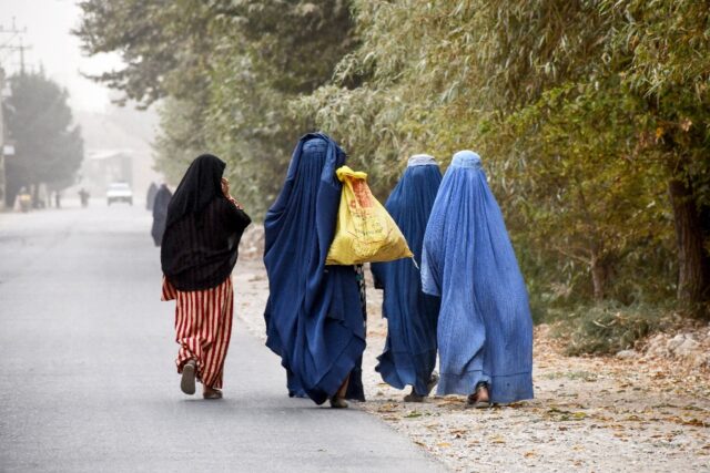 Afghan women walk in the outskirts of the northern city of Mazar-i-Sharif in October 2024