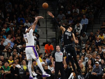 Anthony Davis of the Los Angeles Lakers, left, shoots over San Antonio's Victor Wembanyama