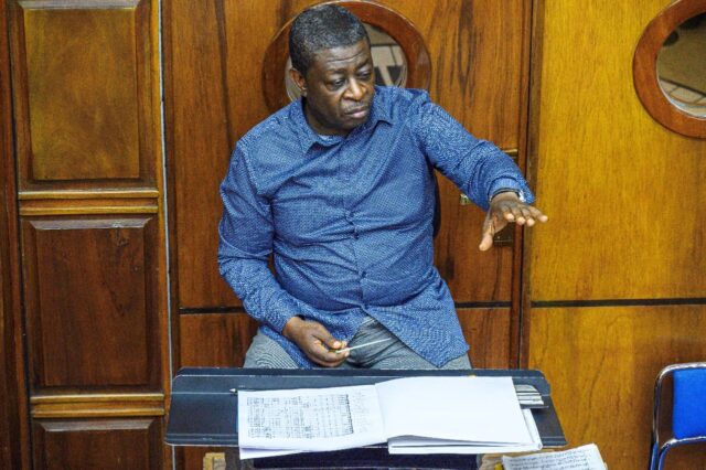 Armand Diangienda conducting at a rehearsal at the Kimbanguist Symphony School in Kinshasa