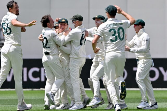 Australia celebrate the wicket of India's Yashasvi Jaiswal in the first Test