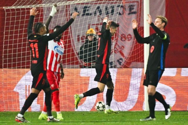 Barcelona's Polish forward Robert Lewandowski (C) celebrates after scoring in the rout of