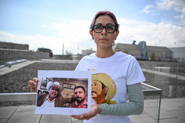 Brenda Diaz Valencia is seen in Washington holding a photo of her father, Antonio Diaz Val