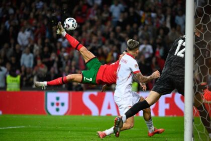 Cristiano Ronaldo (L) scored his 135th goal for Portugal with an overhead kick